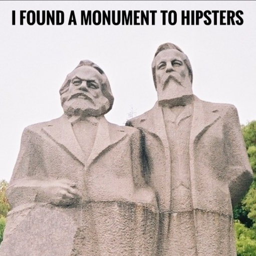 A picture of statues of Marx and Engles with a caption I found a monument to hipsters as the statue representing them makes them look like hipsters.